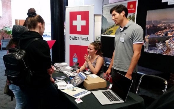 Nicolas Oestreicher, Swiss student of geology at Victoria University and stall organiser and Abby, student from New Zealand with a study exchange experience at the University of St. Gallen in Switzerland. 
