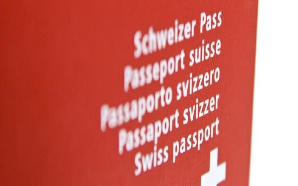 Cover of the Swiss passport, with the words 'Swiss passport' printed in the four national languages and in English. 