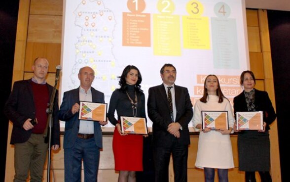 Minister for Local Affairs Bledi Çuçi with representatives from seven municipalities receiving prizes for best practices in local governance. 