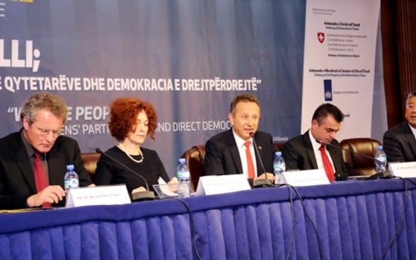 Swiss Ambassador Christoph Graf with other international representatives addressing the conference on direct democracy. 