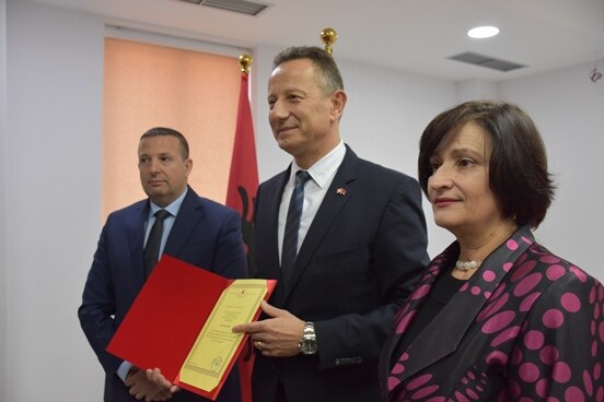 Mayor of Berat Petrit Sinaj with Swiss Ambassador Christoph Graf (centre) and Chairwoman of Municipal Council Nikoleta Manka during the honorary citizenship award ceremony