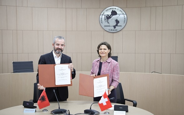 Albania's State Commissioner for Elections Ilirjan Celibashi and Swiss Ambassador Ruth Huber after signing agreement on new cooperation for improved effectiveness of the Central Elections Commission.