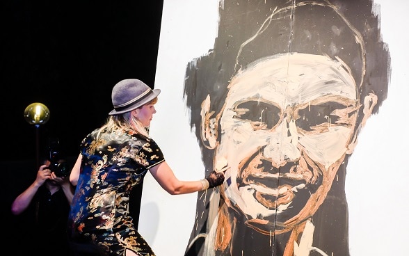 Speed-painting artist Corinne Sutter performs at the closing ceremony of the innovation week.