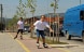 Two young people rollerblading on a cycle path.. 