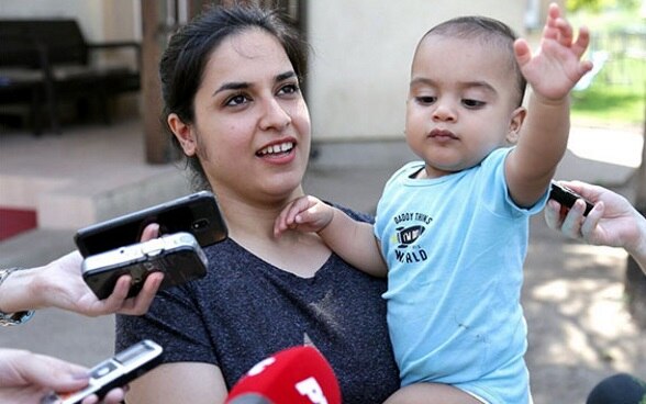 Reception center for migrants in Subotica, Marua Hamza with son
