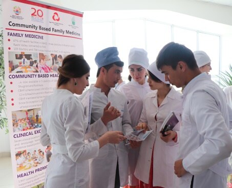 Tajik medical students discussing SDC health leaflets