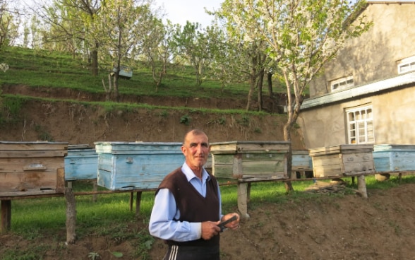 Abdulahad with his bee hives. Behind him there is a terrace of plants for slop stabilisation. This type of planting prevents landslide. © Billi Bierling 