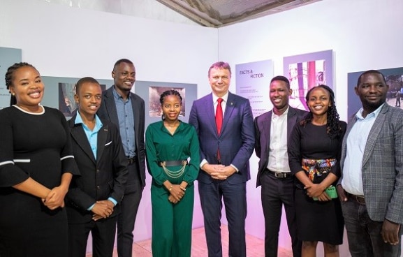 Swiss Ambassador Didier Chassot with IHL students from the University of Dar es Salaam School of Law at the exhibition launch.