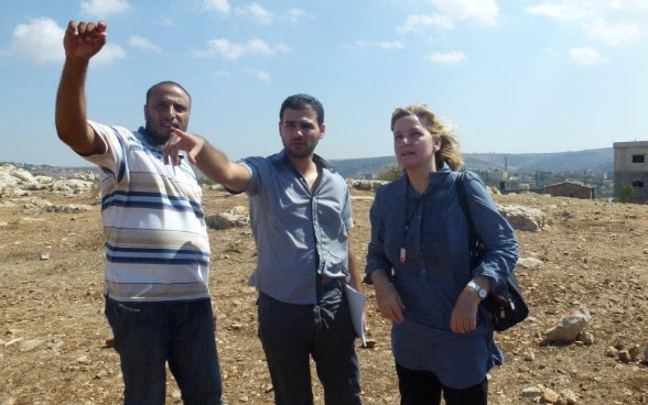 Johanna Estermann listens to two Lebanese partners during a field visit