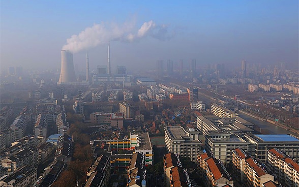 A thick cloud of smoke rises from a factory in Huai’an City in eastern China. 