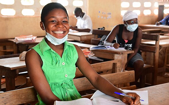 A girl with a face mask in a village school in Mali.