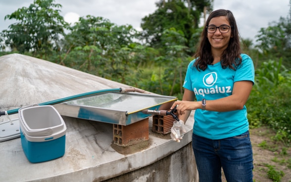 Anna Luisa Beserra, young entrepreneur from Brazil, next to a water tank.