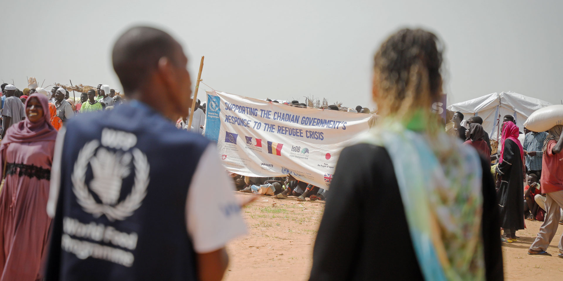 La directora de la COSUDE, Patricia Danzi, y un representante del PMA frente al campo de refugiados en Adré, Chad, en la frontera con Sudán.