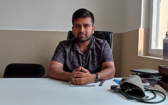 A man sits at his desk.