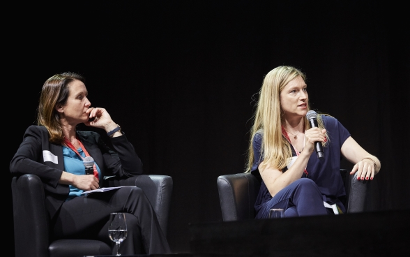 Davorka Shepherd and Andrea Heinzer sitting on stage. Andrea Heinzer speaking into a microphone.