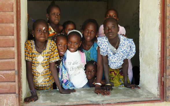 School girls in Mali standing at their classroom window