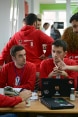 Four young developers sitting at a table discussing IT solutions designed to help the municipality create more transparency.