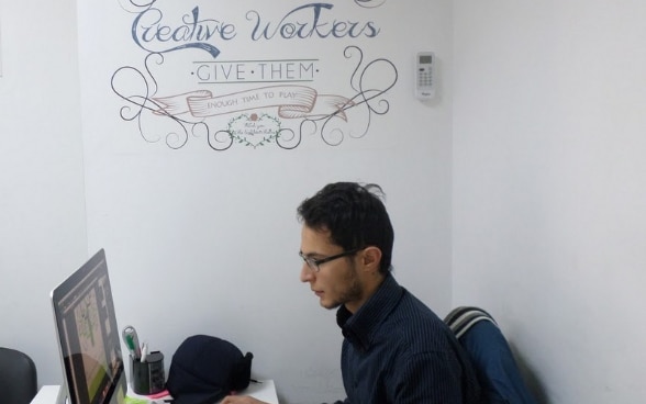 Khaled Ben Salem, 25, working in front of his computer