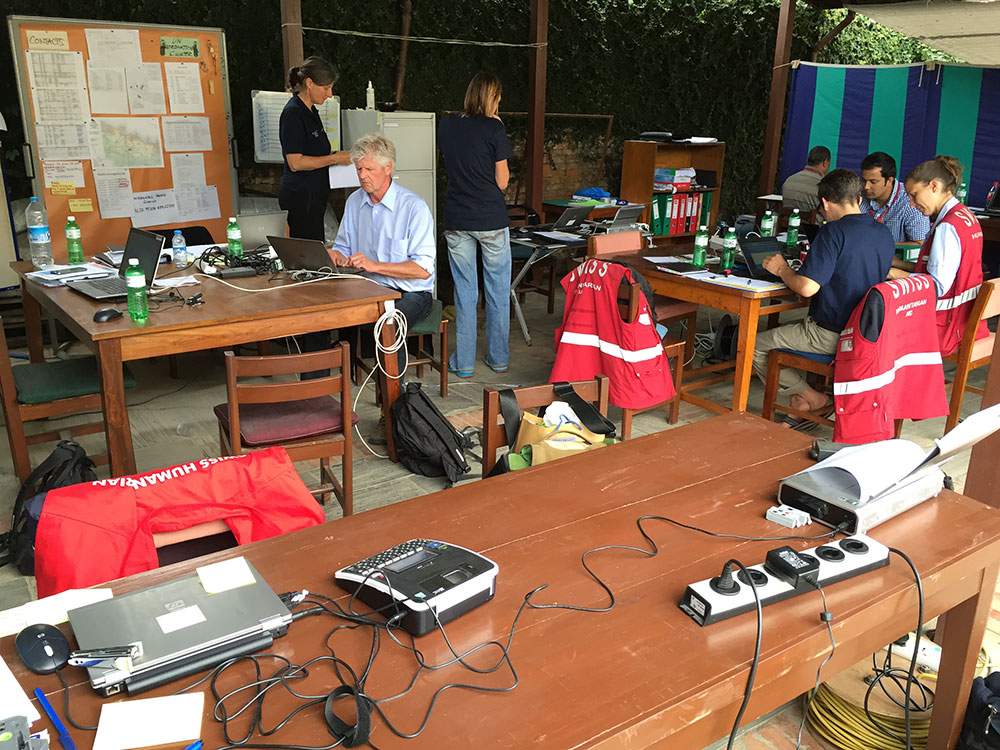 Collaboratori dell’Aiuto umanitario svizzero lavorano in un ufficio equipaggiato di telefoni e computer. 