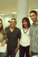 Four young employees at a "practice firm" standing with their work certificates