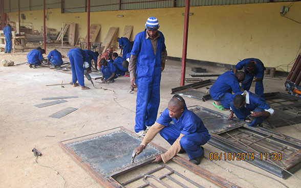Apprentice welders work under the supervision of an instructor. 