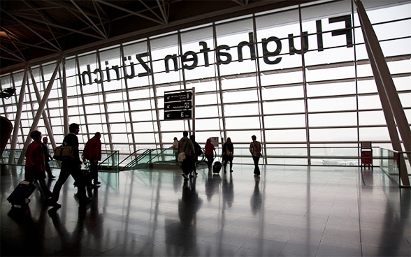 Travellers with their luggage at Zurich airport 