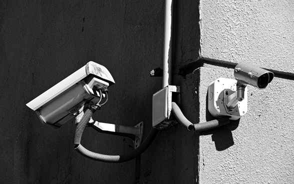 A surveillance camera on a wall.