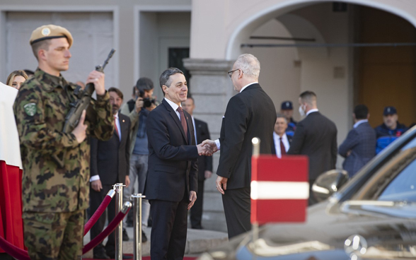 President of the Swiss Confederation Ignazio Cassis and President Egils Levits of Latvia shake their hands at the Piazza Riforma in Lugano. 