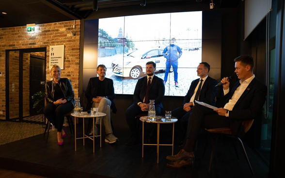 Four men and one woman during a panel discussion.