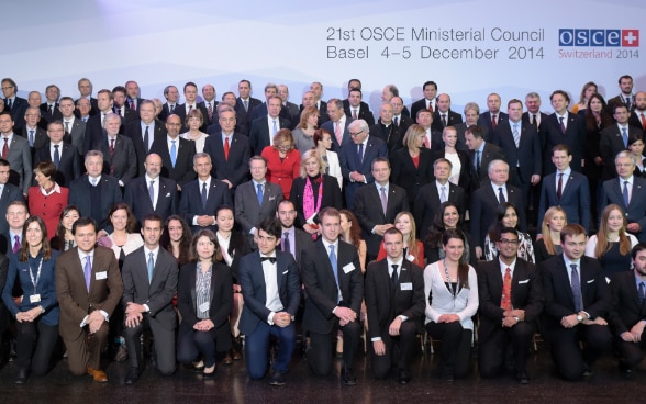 The OSCE youth ambassadors posing for a group photo with the foreign ministers at the Ministerial Council meeting in December 2014