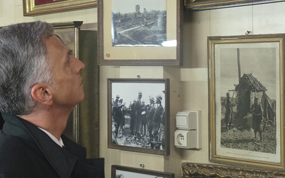  Didier Burkhalter looking at black-and-white photographs in the museum at the "Hill 62" First World War trench near Ypres in Belgium