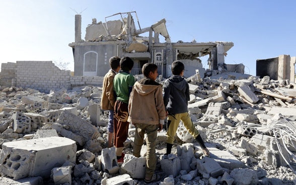 Yemeni children inspect a building in Sanaâ hit by air strikes.