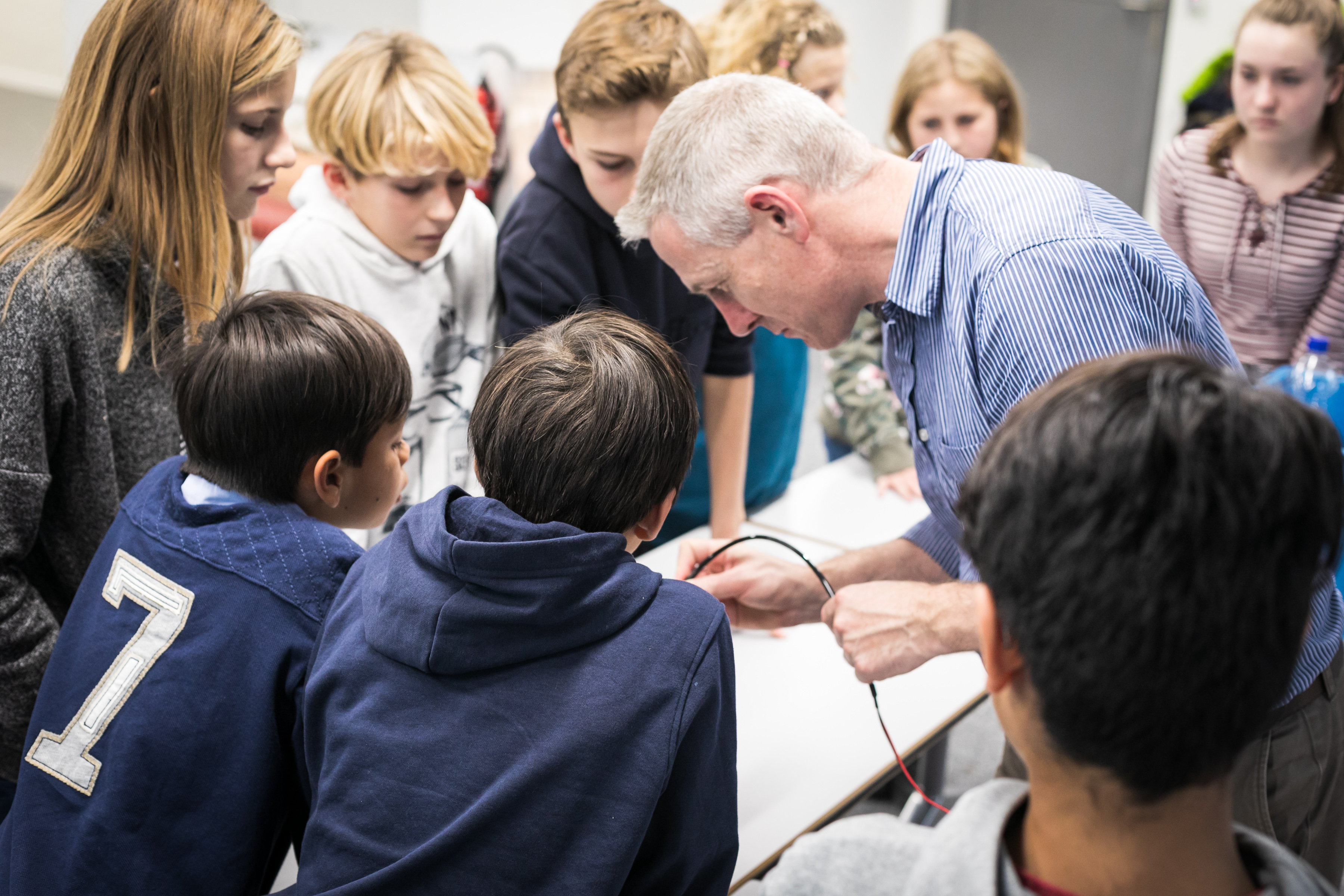 A man shows children how water is purified to make it drinkable.