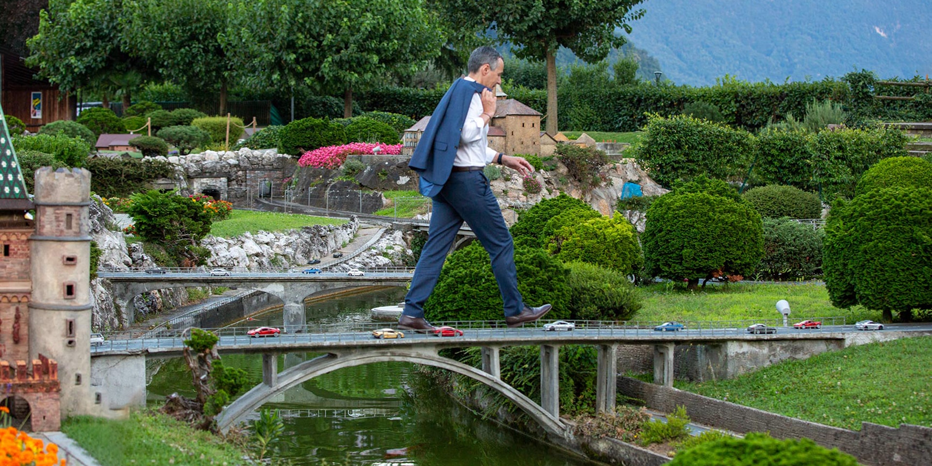  Federal Councillor Ignazio Cassis walking across a miniature motorway bridge at Swissminiatur.
