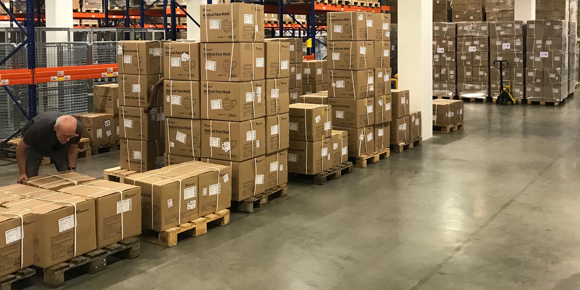 View into the depot of the Humanitarian Aid with boxes stacked on transport pallets.