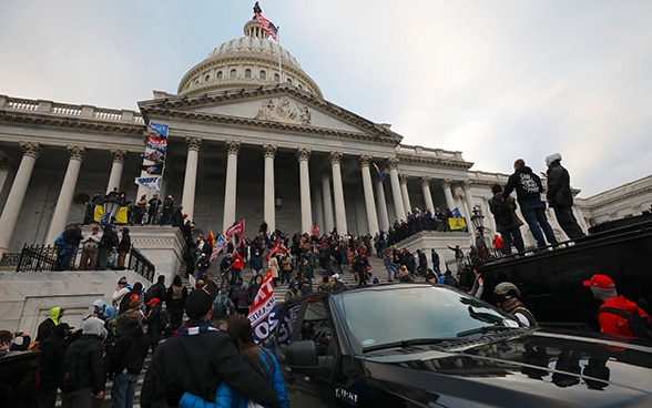 The Capitol in Washington, with protesters standing on its steps, seeking entrance to the Capitol.