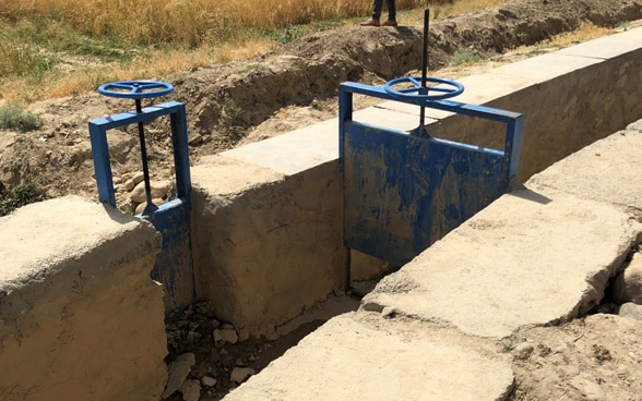  The blue-painted locks of the irrigation canal stand out against the arid Afghan landscape.