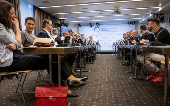 During the break-out session on digitalization and reconstruction, participants listen to the speakers.