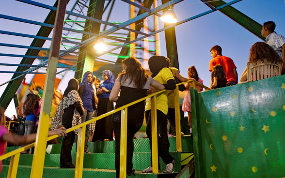 Young people stand on a staircase.