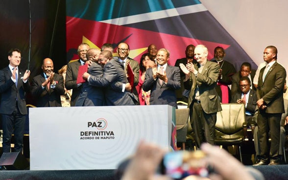 The parties to the conflict in Mozambique embrace after signing a peace agreement in 2019. 
