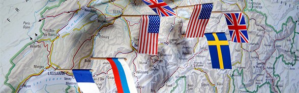 Map of Switzerland with several international flags