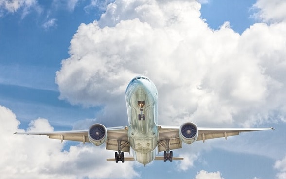 A plane with clouds in the background.