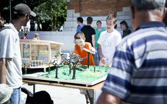 Two schoolchildren with a solar energy model they made themselves. 