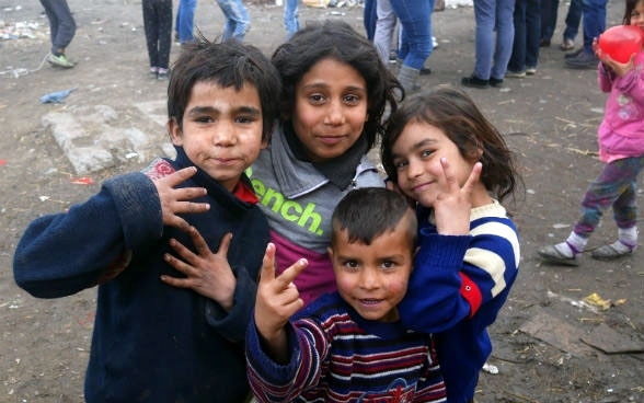 Quatre enfants roms prennent la pose.