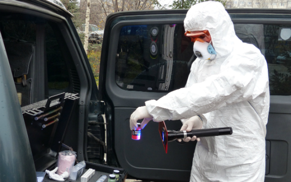 A man in a white protective suite controls things