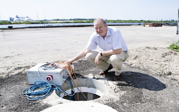 A man in front of a remediation well