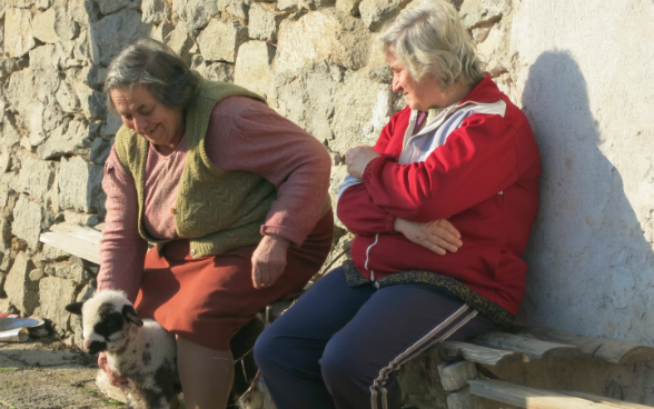 two old women sitting on a bench