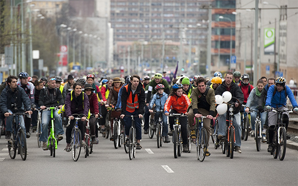 A large group of cyclists in a city