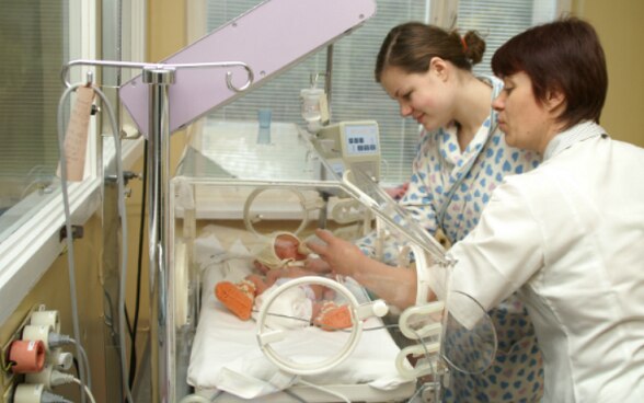 A doctor with a mother and her baby